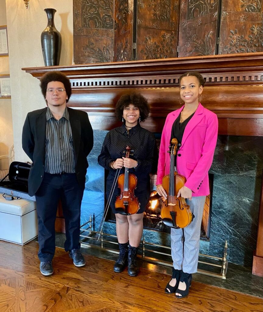 Penn Griffin Orchestra Director Damien Miles and violinists Bianca Jones and Brice Dale entertained guests at the March 13 luncheon.